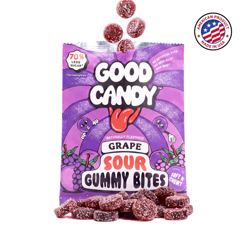 Purple sugar-coated grape gummy candy spilling out of an open Good Candy grape bag, with a Made in USA badge