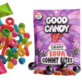 Good Candy grape bag with purple sugar-coated grape gummy candy and whole grapes, beside assorted colorful sour candies