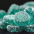 Close-up of Good Candy Blue Razz low sugar sour gummies coated in sparkling sugar crystals