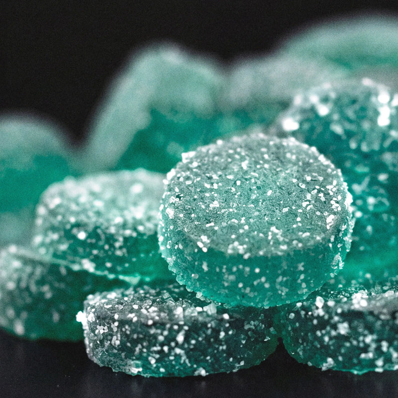 Close-up of Good Candy Blue Razz low sugar sour gummies coated in sparkling sugar crystals