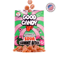 Orange watermelon gummy candy spilling out of an open Good Candy watermelon bag, with a Made in USA badge