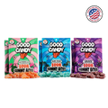 Watermelon, blue razz, and grape bags of Good Candy sour gummy candy lined up with piles of matching sugar-coated gummies and a Made in USA badge